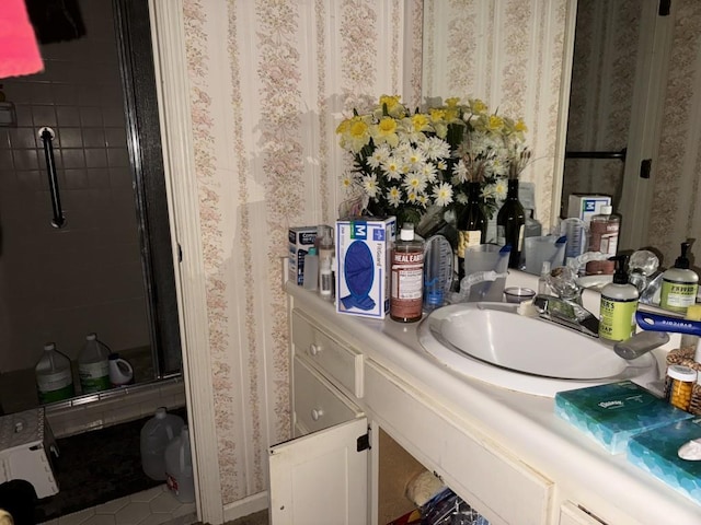 bathroom featuring an enclosed shower, vanity, and tile patterned floors