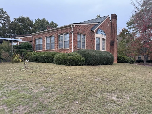 view of side of property with a lawn