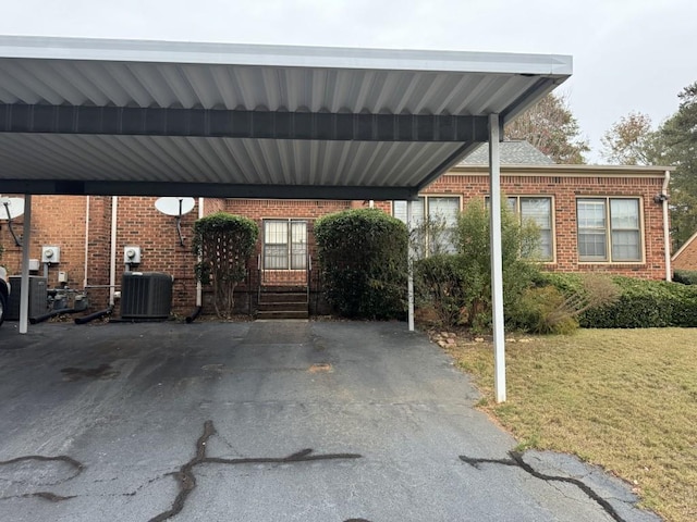 view of vehicle parking with a yard and a carport