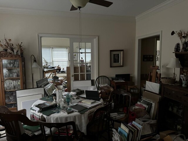 dining area with ornamental molding and ceiling fan