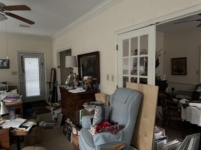 misc room with ceiling fan, carpet floors, and ornamental molding