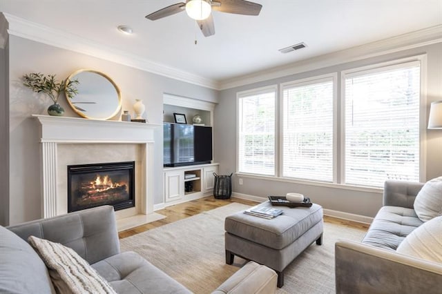 4765 Silver Leaf Dr, Cumming, GA 30040 - living room featuring a ceiling fan, light wood finished floors, a premium fireplace, and crown molding