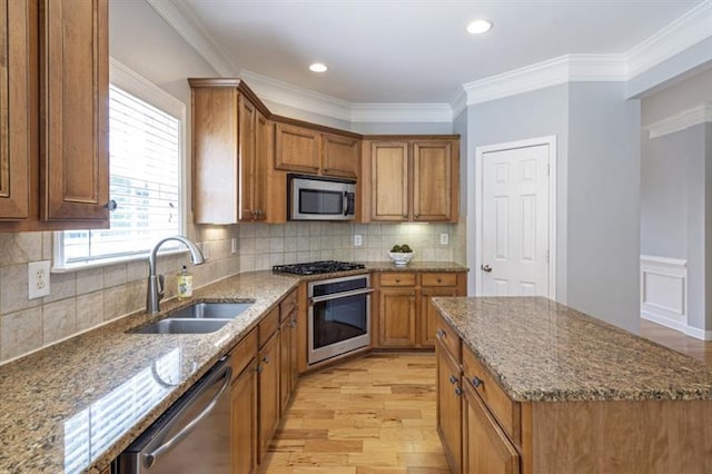 4765 Silver Leaf Dr, Cumming, GA 30040 - kitchen featuring appliances with stainless steel finishes, brown cabinetry, light wood-style floors, dark stone countertops, and crown molding