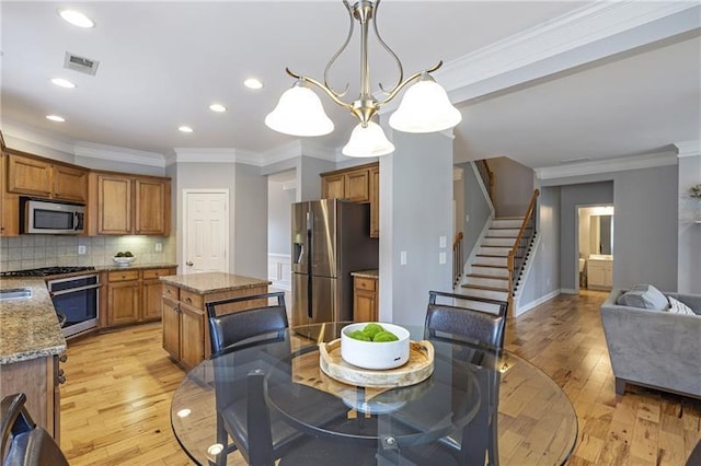 4765 Silver Leaf Dr, Cumming, GA 30040 - dining space featuring stairs, ornamental molding, light wood finished floors, and recessed lighting