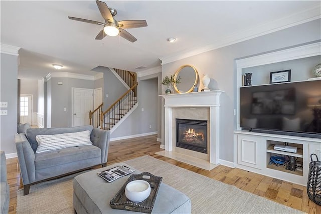 4765 Silver Leaf Dr, Cumming, GA 30040 - living area featuring stairway, crown molding, wood finished floors, ceiling fan, and a high end fireplace