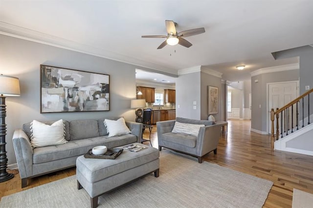 4765 Silver Leaf Dr, Cumming, GA 30040 - living room featuring ornamental molding, a ceiling fan, stairway, and light wood finished floors