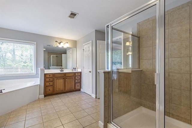 4765 Silver Leaf Dr, Cumming, GA 30040 - bathroom with vanity, tile patterned floors, a bath, and a stall shower