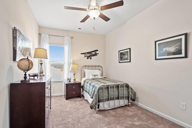 bedroom featuring light colored carpet and ceiling fan