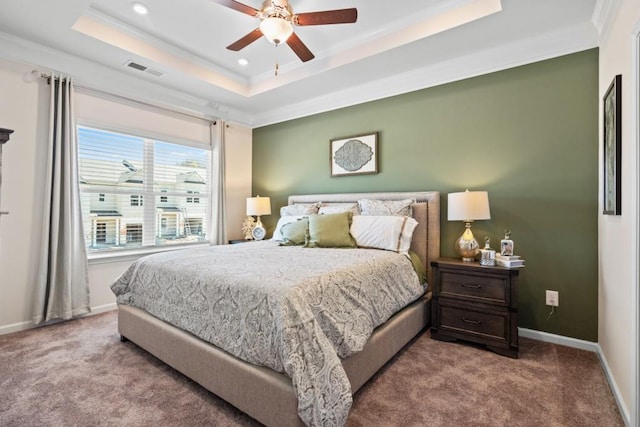 carpeted bedroom with crown molding, a raised ceiling, and ceiling fan