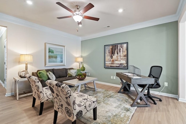 home office with crown molding, ceiling fan, and light hardwood / wood-style floors