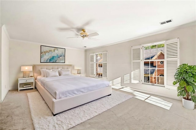 bedroom with carpet floors, visible vents, crown molding, and ceiling fan