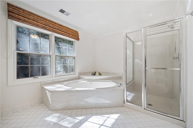 bathroom featuring a bath, tile patterned floors, a stall shower, baseboards, and visible vents