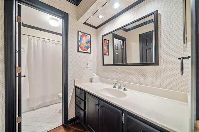 bathroom featuring toilet, vanity, tile patterned floors, and wallpapered walls