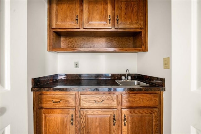 bar with indoor wet bar and a sink