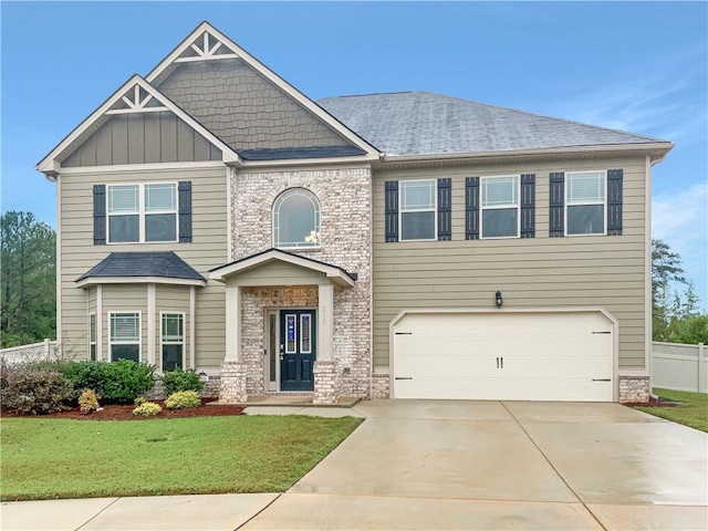 craftsman-style home featuring a front lawn and a garage