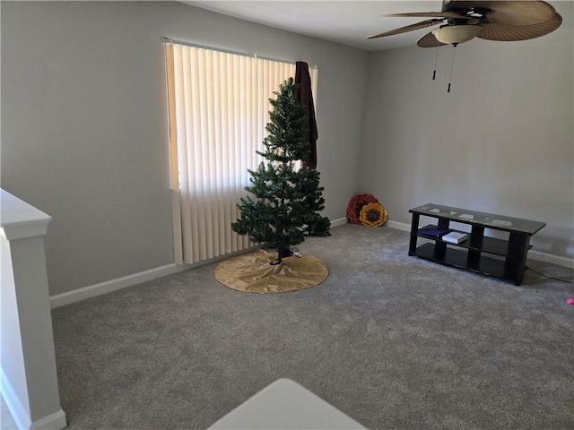 living area featuring carpet flooring and ceiling fan