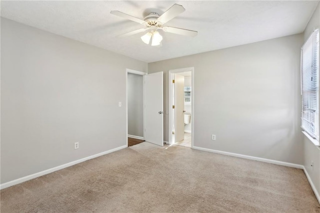 empty room featuring light carpet and ceiling fan