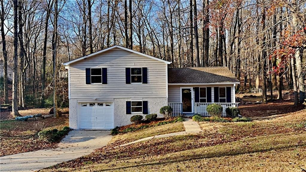 split level home with covered porch and a garage