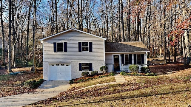 split level home with covered porch and a garage