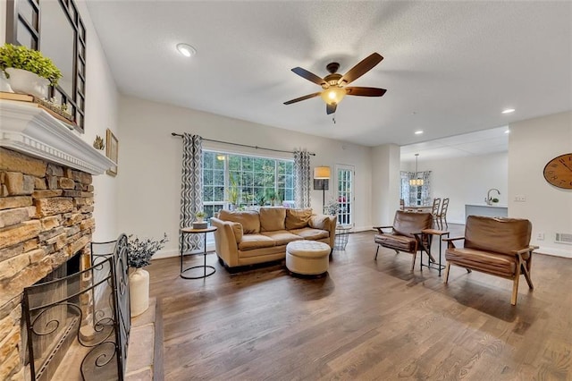 living room featuring a fireplace, hardwood / wood-style floors, and ceiling fan