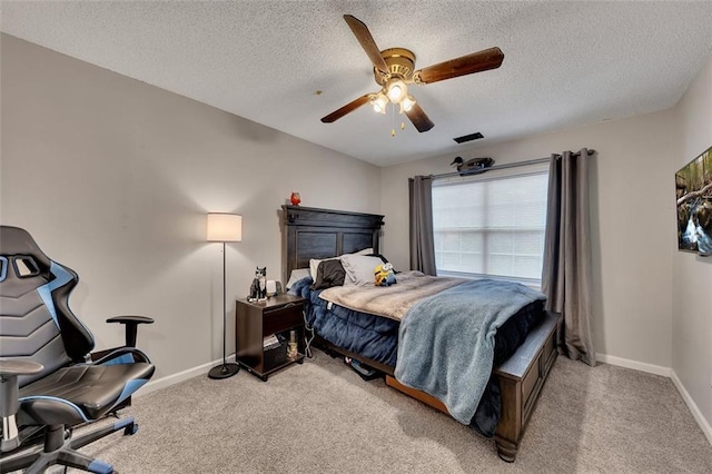 carpeted bedroom featuring a textured ceiling and ceiling fan