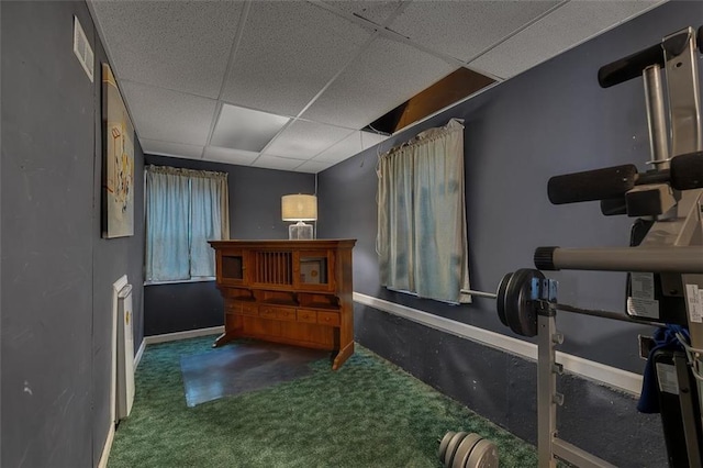 interior space featuring carpet flooring and a paneled ceiling