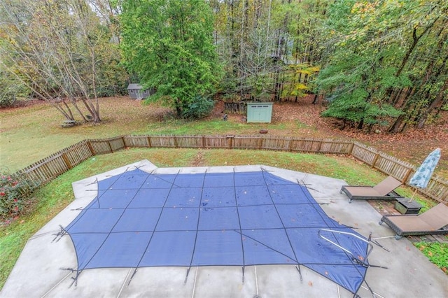 view of pool with a yard