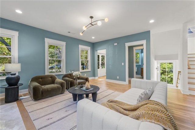 living room with light wood-type flooring and plenty of natural light