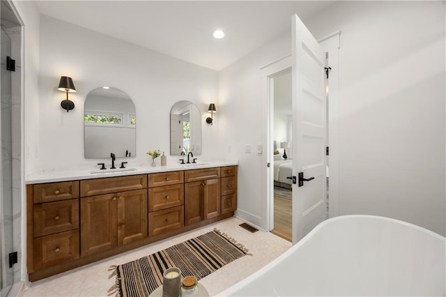 bathroom featuring vanity and a tub to relax in