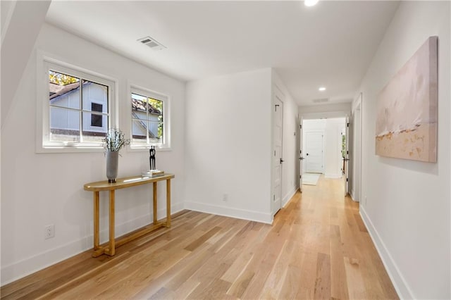 corridor with light wood-type flooring