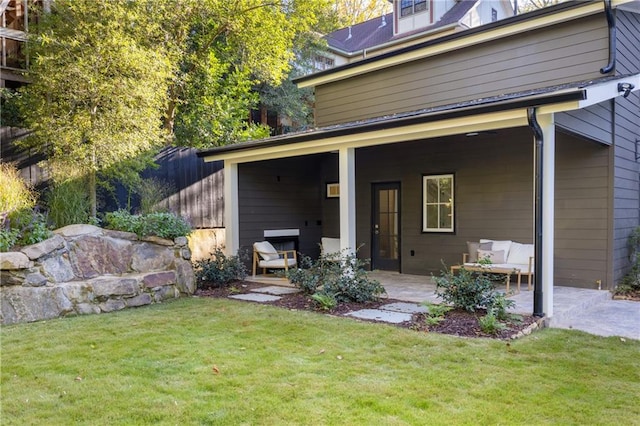 back of property featuring a patio area and a lawn