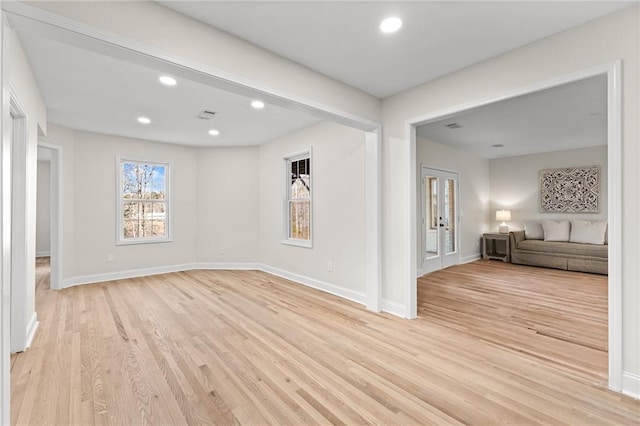 unfurnished room with recessed lighting, light wood-style floors, and french doors