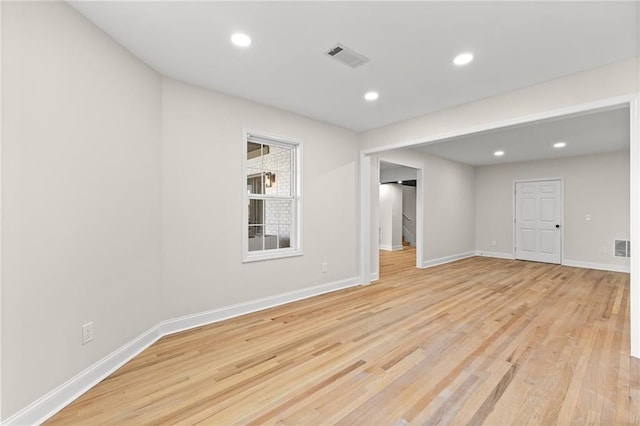 unfurnished room featuring recessed lighting, light wood-style floors, visible vents, and baseboards