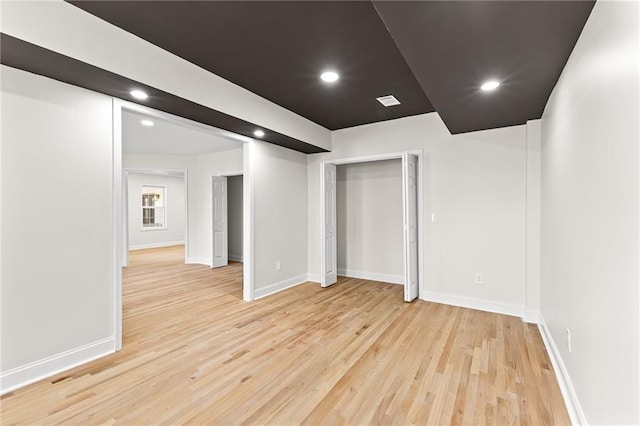 interior space with light wood-style flooring, recessed lighting, and baseboards