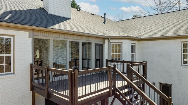 deck featuring stairs and a sunroom