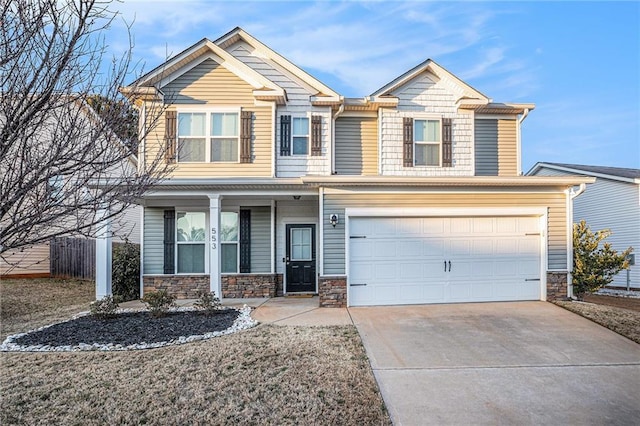 craftsman-style house with driveway, a garage, stone siding, covered porch, and fence