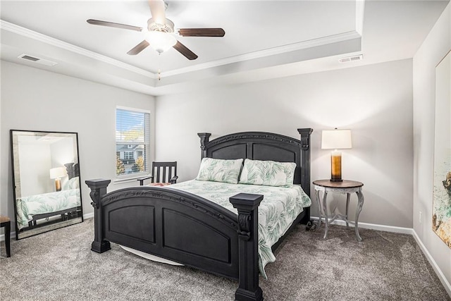 carpeted bedroom featuring a ceiling fan, baseboards, visible vents, and a tray ceiling