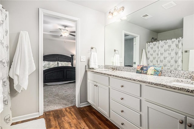 ensuite bathroom featuring double vanity, visible vents, and a sink