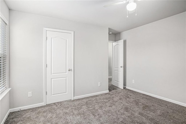 unfurnished bedroom featuring a ceiling fan, carpet, and baseboards