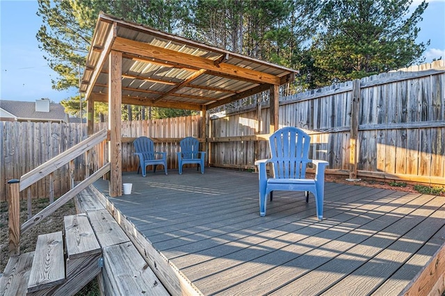 wooden deck featuring a fenced backyard and a pergola