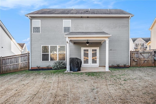 back of house featuring a patio, ceiling fan, a fenced backyard, a gate, and french doors