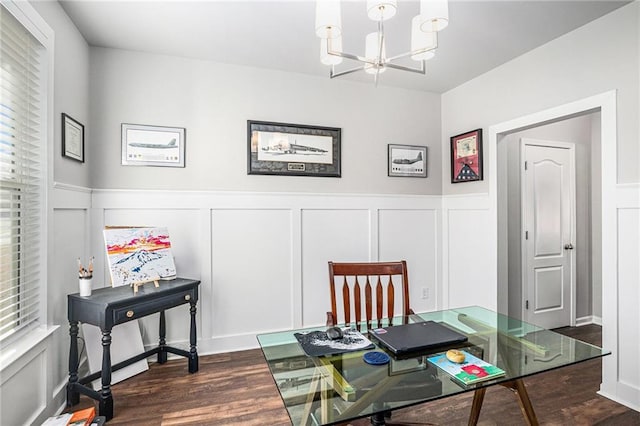 home office featuring an inviting chandelier, dark wood-style floors, a decorative wall, and a wainscoted wall
