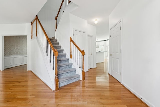 stairway with hardwood / wood-style flooring