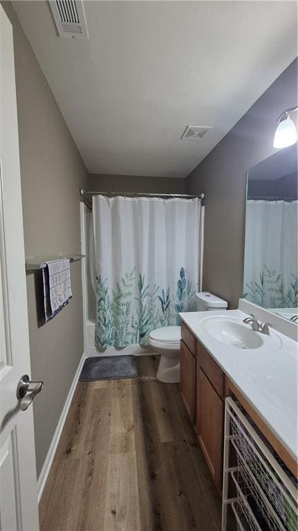 1015 Pebble Creek Trl, Suwanee, GA 30024 - full bath featuring toilet, vanity, wood finished floors, and visible vents