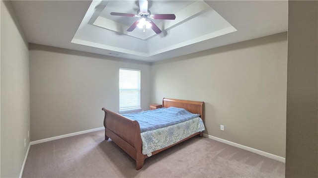 1015 Pebble Creek Trl, Suwanee, GA 30024 - carpeted bedroom featuring baseboards, a ceiling fan, and a tray ceiling