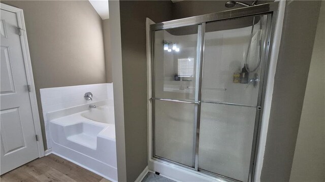 1015 Pebble Creek Trl, Suwanee, GA 30024 - full bathroom featuring a bath, a shower stall, and wood finished floors
