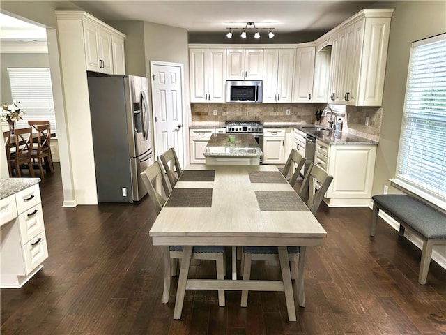 1015 Pebble Creek Trl, Suwanee, GA 30024 - kitchen featuring light stone countertops, appliances with stainless steel finishes, decorative backsplash, and a sink