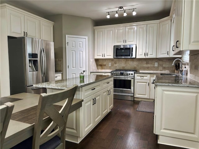 1015 Pebble Creek Trl, Suwanee, GA 30024 - kitchen featuring light stone countertops, decorative backsplash, stainless steel appliances, and a sink