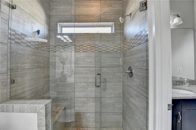 full bathroom with a stall shower and vanity