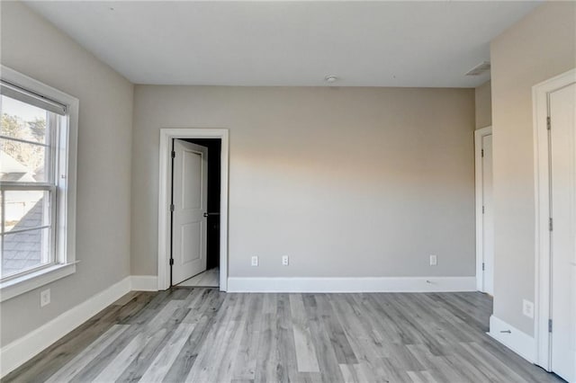 unfurnished bedroom with light wood-style flooring and baseboards